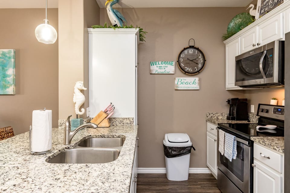 Your fully equipped kitchen awaits with granite counters, stainless appliances, and charming coastal touches that make meal prep a breeze.