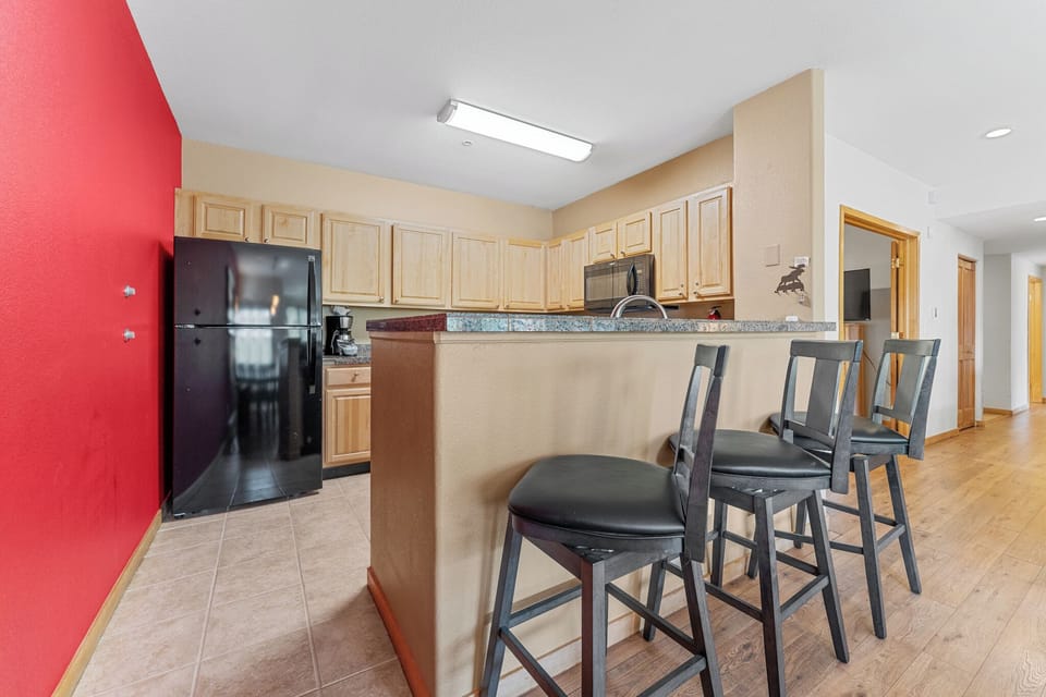 Your fully equipped kitchen features granite counters, bar seating for four, and everything you need to create memorable meals together.