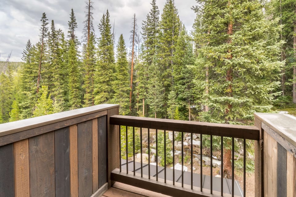 Private deck with forest views off the Primary Suite