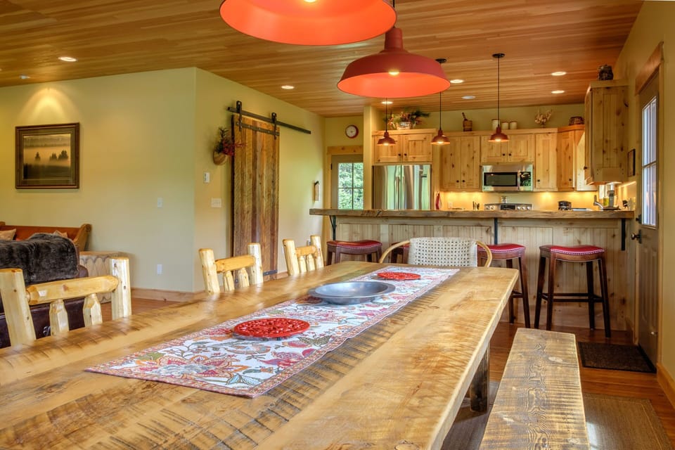 The cozy living room has a gas fireplace, a flat screen HD TV with satellite service, an iPod dock and comfy leather seating. Double French doors open to the covered porch with additional seating for cocktail hour!