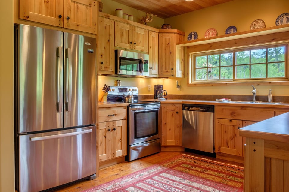 This is a great kitchen for a crowd as it opens to the bar, the dining area, and the living room. It’s equipped with all stainless appliances, a smooth top electric range, tons of serving and picnic ware, and lots of small appliance extras like a crock pot, electric mixer and blender.