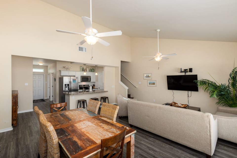 Relax in your open-concept living space with rustic dining, modern kitchen, and cozy seating area for memorable vacation moments.
