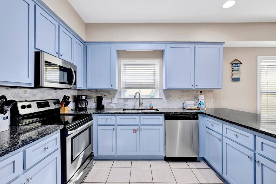Updated kitchen with stainless appliances, granite and tile backsplash