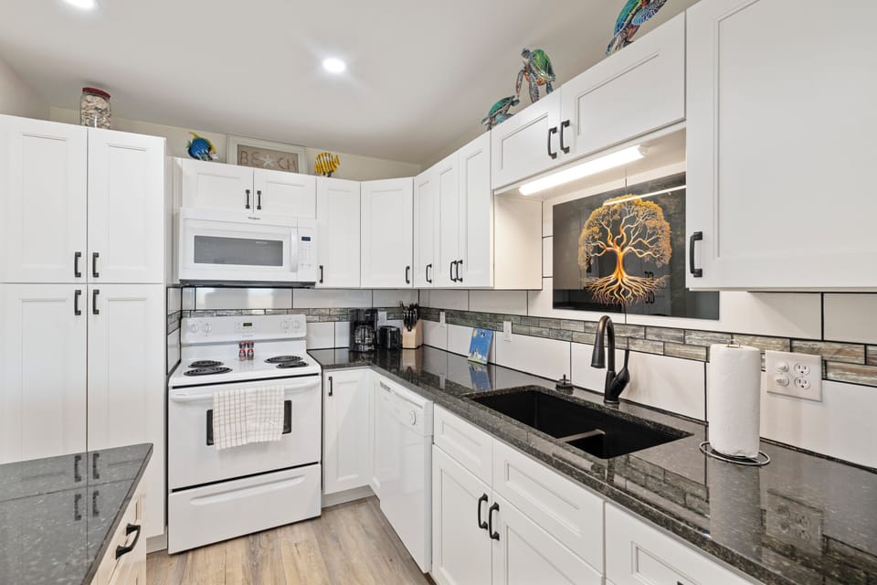 Your fully equipped kitchen features crisp white cabinets, granite counters, and modern appliances for memorable meal prep.