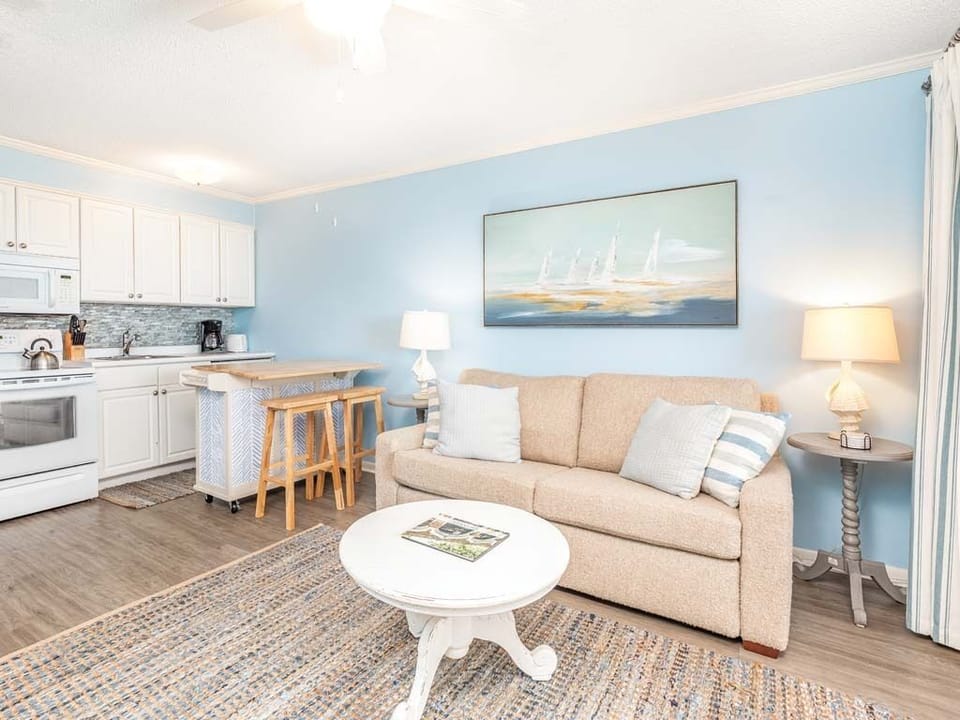 Living area with sleeper sofa, TV and access to balcony