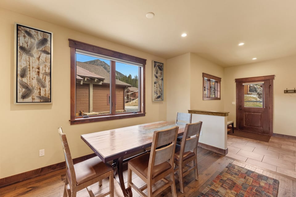Gather around this warm wood dining table where your mountain meals become memorable moments together.