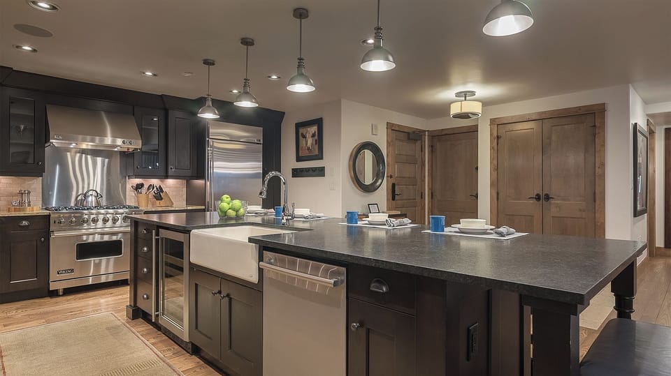 Your gourmet kitchen features professional-grade appliances and a spacious island where you can prepare memorable meals with loved ones.
