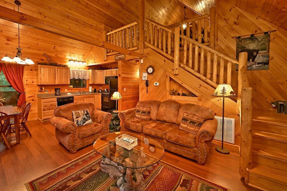 Cabin has a huge 2 person shower. Relax on the wooden rocking ch - View of beautiful living room and view of upstairs as well.