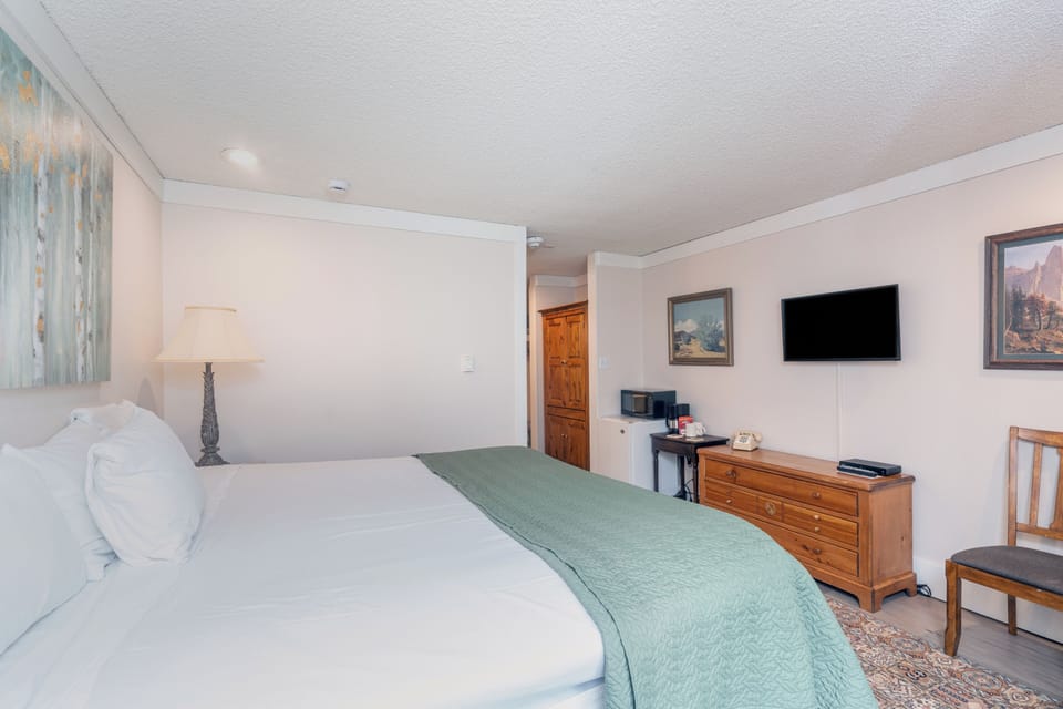 Sink into plush white linens and unwind in your spacious bedroom, where soft lighting and a calming palette create the perfect retreat after a day of adventure.