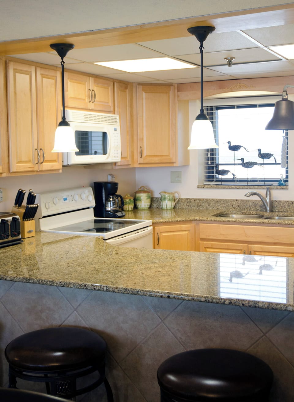 Beautiful kitchen with oak cabinetry and granite counter tops!  Everything you need to make a quick snack or a gourmet meal...it's up to you!  Both Keurig and drip coffee makers are provided.