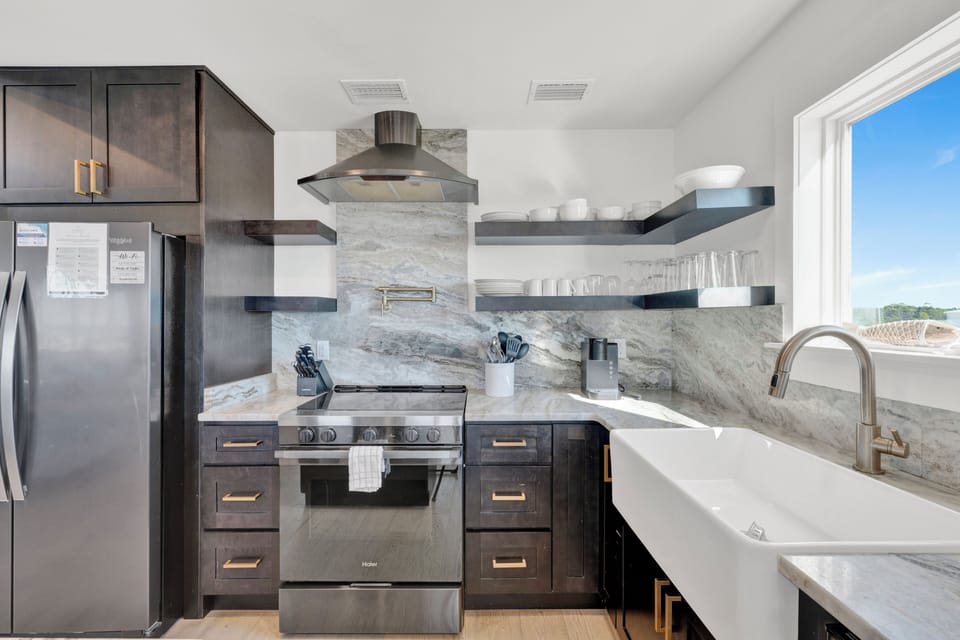 Featuring stainless appliances and stone counters