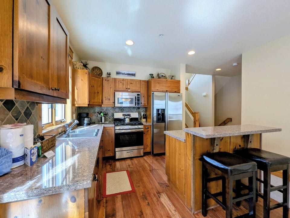 Gather around this beautifully equipped kitchen where granite counters and warm wood cabinets create the perfect space for your culinary adventures together.