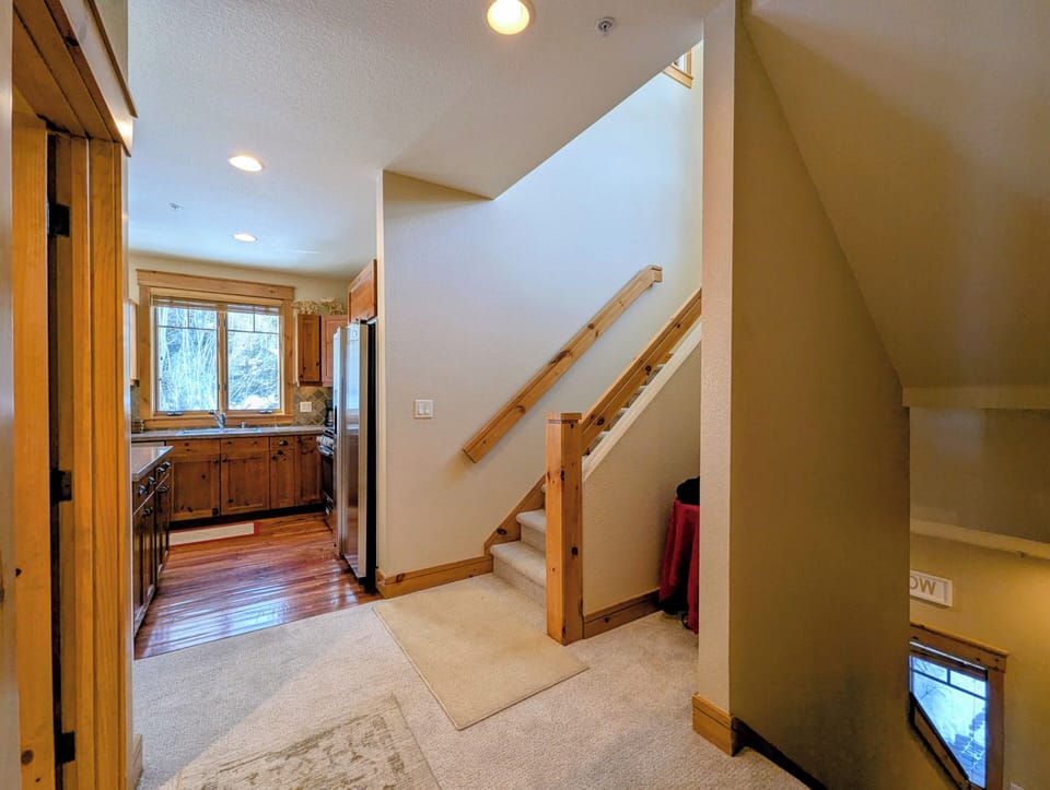 Warm wood accents and soaring ceilings create an inviting atmosphere as you move between your spacious kitchen and upstairs retreat.