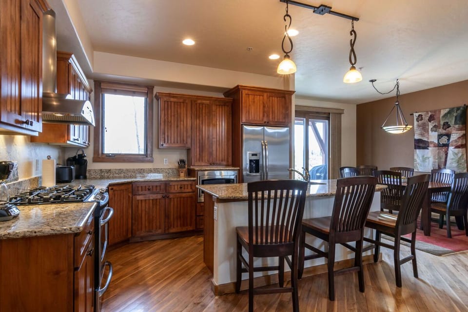 The open kitchen features three seats at the breakfast bar