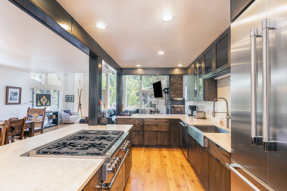 A culinary masterpiece—this chef's kitchen is outfitted with top-of-the-line stainless steel appliances, designer fixtures, and sleek, modern finishes