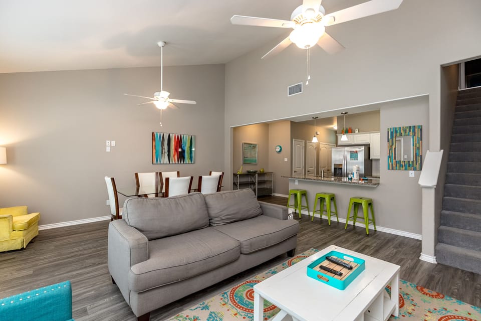 Relax in your bright open-concept living space with modern comfort and vibrant decor creating the perfect vacation home atmosphere.