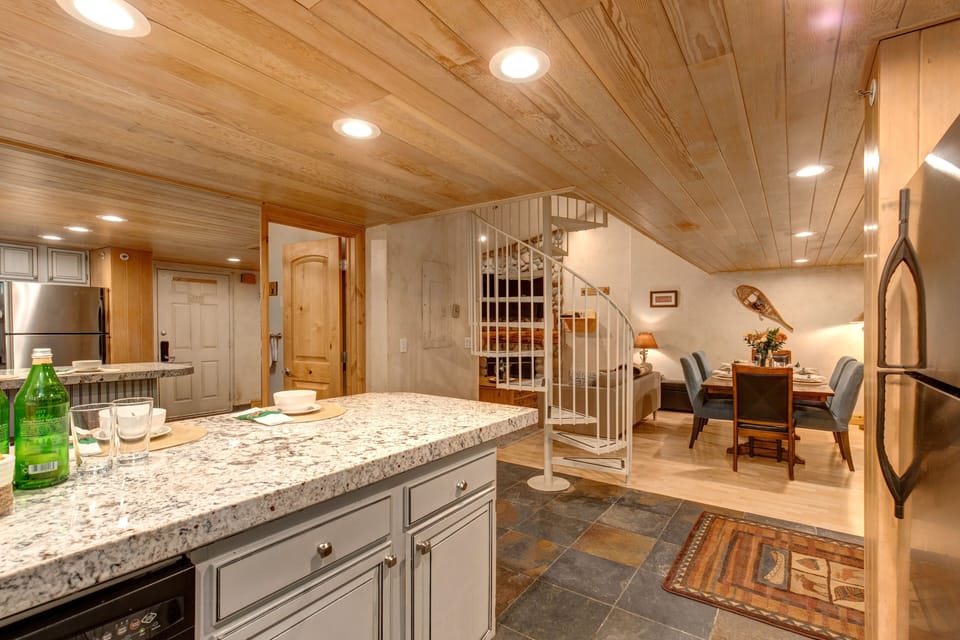 Fully equipped kitchen offering gorgeous quartz counters and stainless steel appliances, and bar with seating for up to four people