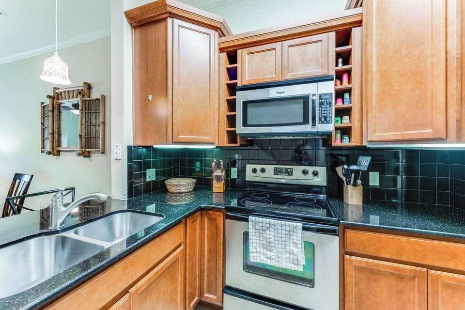 Cook your favorite meals in this fully-equipped kitchen with granite counters, modern appliances, and ample cabinet space for all your essentials.