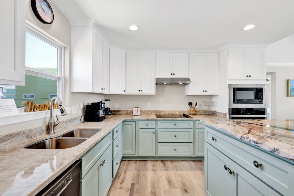 The stunning kitchen is fully equipped for all of your cooking needs