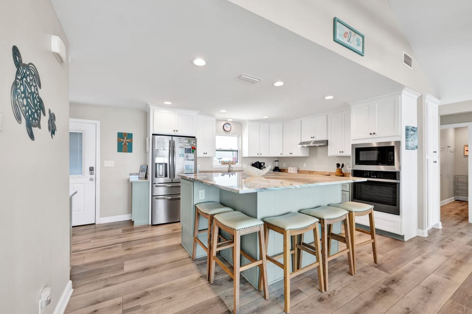 The kitchen features a large island with bar seating