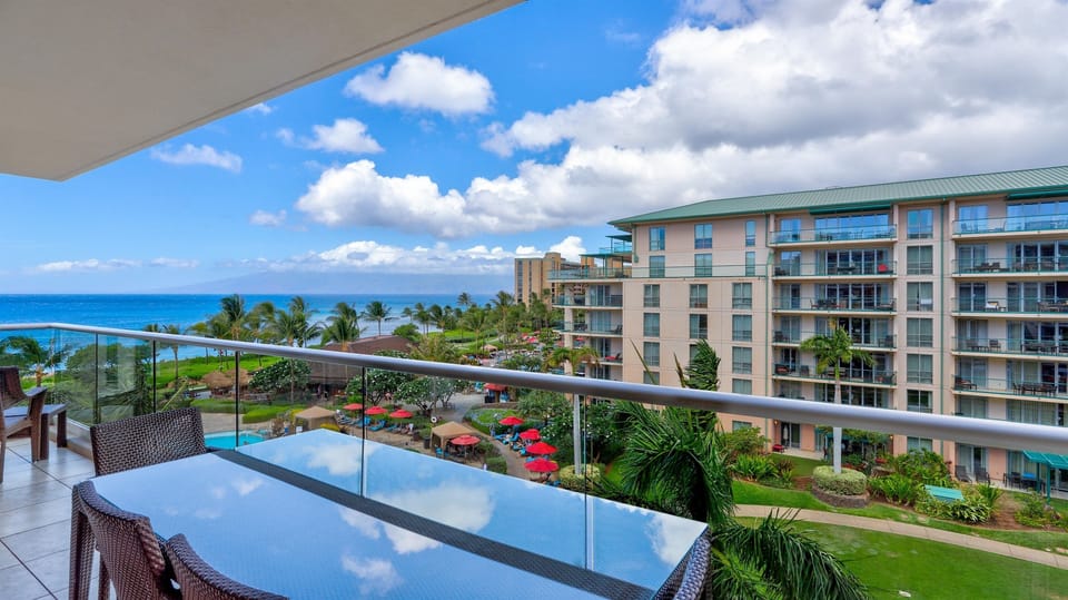 Clear glass balcony railing for unobstructed views of the pool & ocean