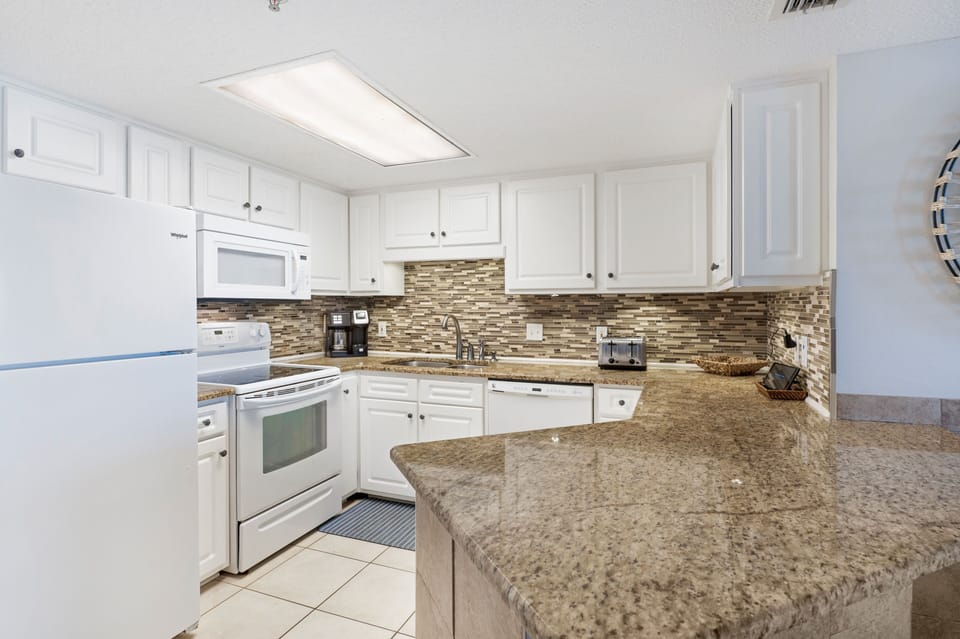 Full Size Kitchen has Upgraded Cabinets and Granite Counter Tops with a Breakfast Bar