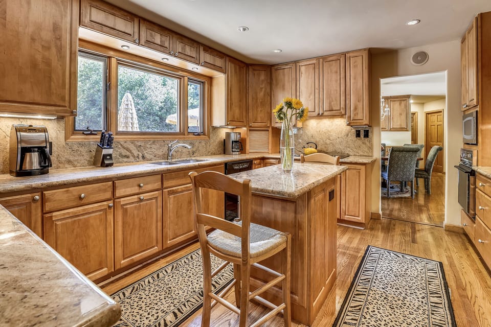 Large open upstairs kitchen overlooks back deck