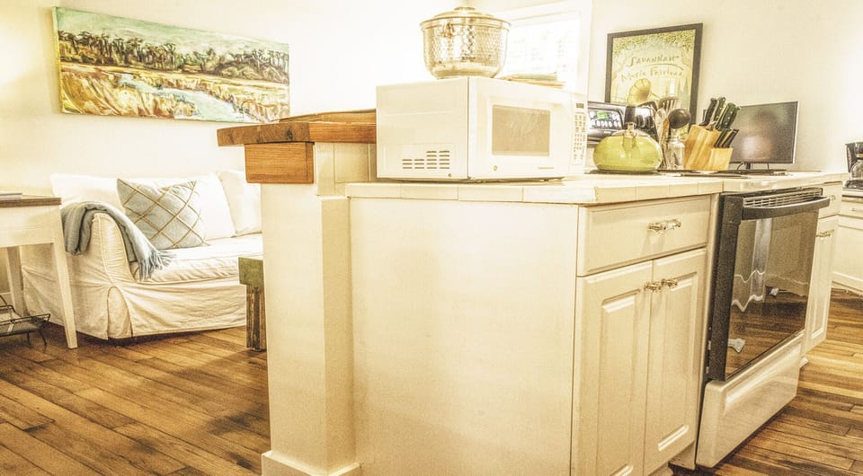 Kithcen and living room - This sweet little kitchen flows right into the living room and has all the essentials for cooking up group meals. Just a heads-up—there’s no dishwasher.