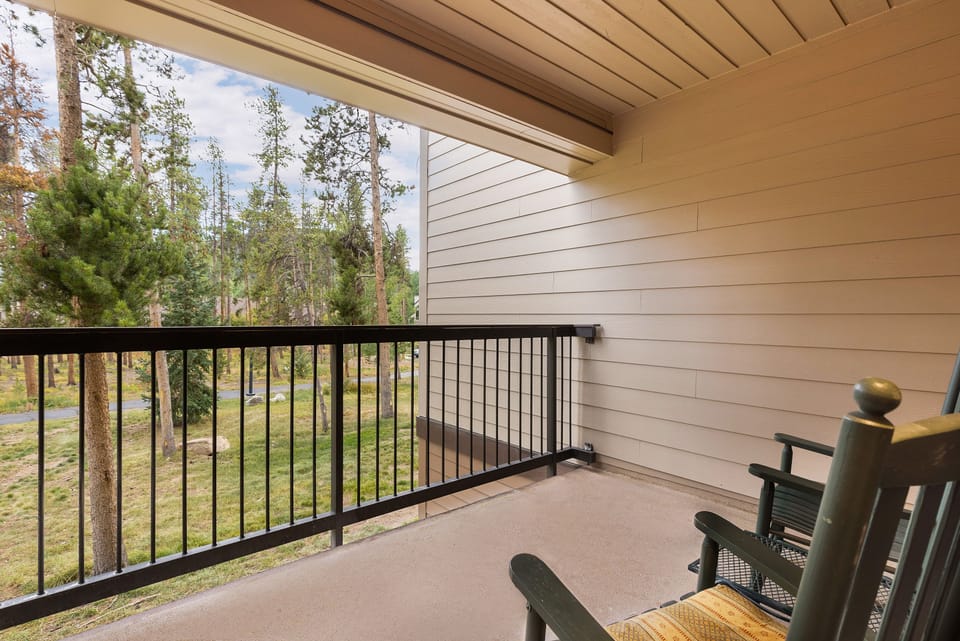 Your private balcony offers peaceful forest views where you can unwind with morning coffee or evening relaxation.
