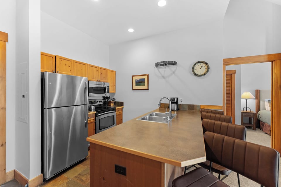 Cook memorable meals in your spacious kitchen with granite countertops, stainless steel appliances, and an island perfect for morning coffee or casual dining.