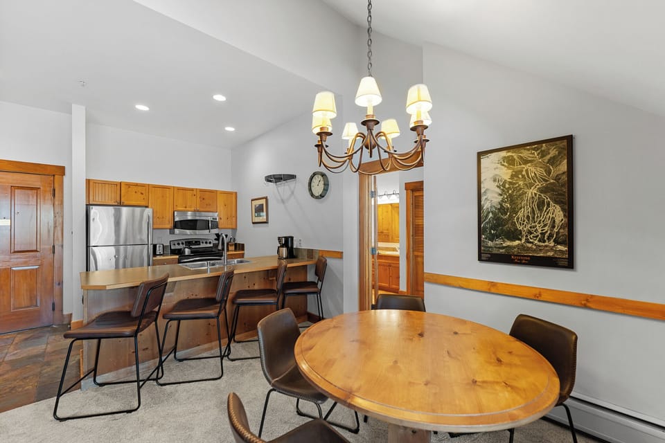 Your spacious kitchen and dining area features warm wood accents, stainless appliances, and an elegant chandelier for memorable meals together.