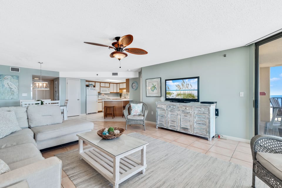 Spacious Living Area with plenty of Comfortable Seating and Balcony Access