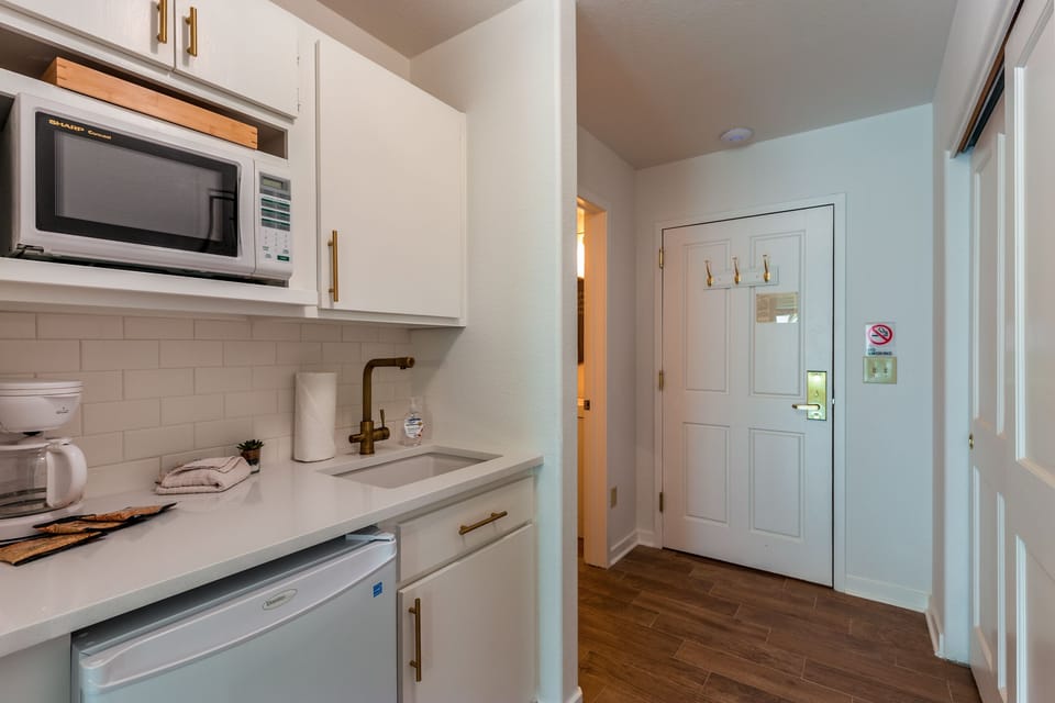Step into your fully-equipped kitchenette with modern appliances and marble countertops, perfect for preparing light meals during your stay.