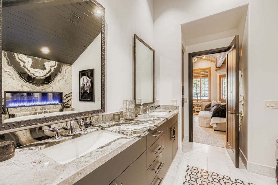 Luxurious master bathroom with dual vanity, soaking tub, and stunning marble details - your private spa retreat awaits.