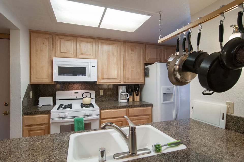 Kitchen sink and breakfast bar makes serving meals and clean up super easy