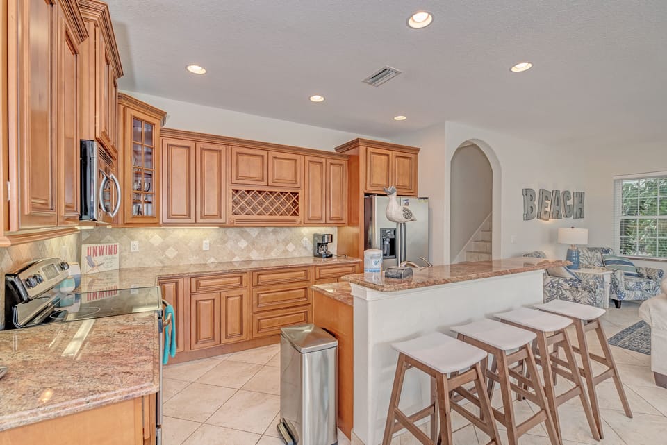 Light brown kitchen with island and stools