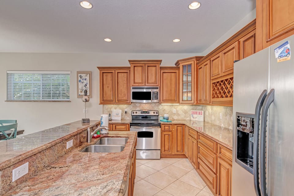 Full kitchen with oven, microwave, sink, and fridge