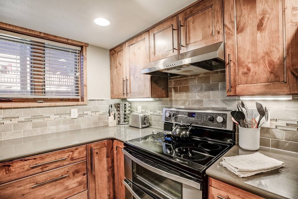 The kitchen features new appliances, a crockpot and blender, and ample counter space for meal prep.