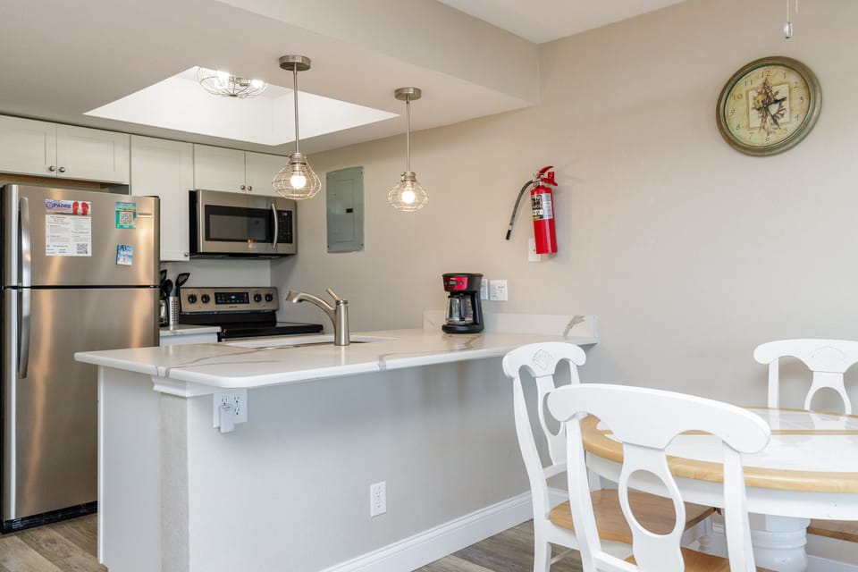 Your bright kitchen features modern appliances and stylish pendant lighting, perfect for preparing meals together.