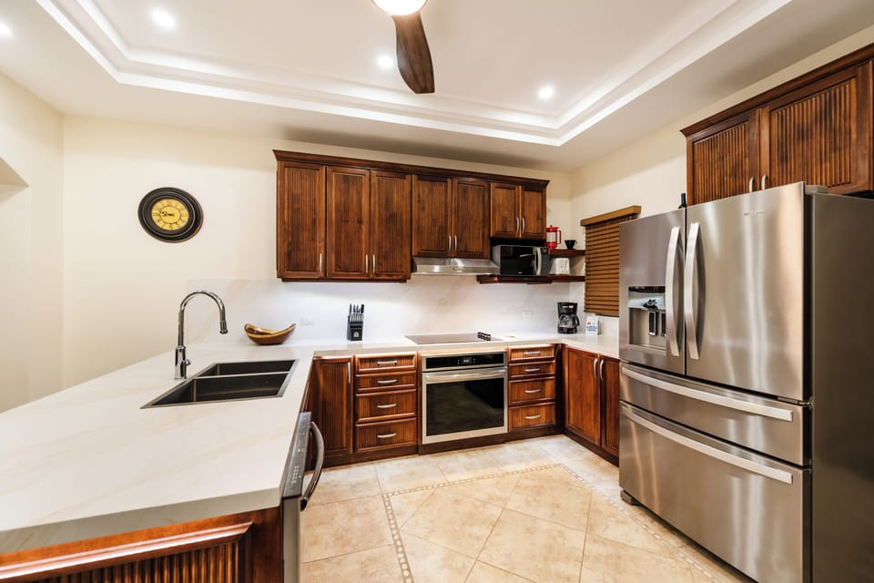 Langosta Beach oceanfront condo with fully equipped kitchen designed for gatherings. Costa Rica luxury rental near Tamarindo featuring open spaces, tropical style, and family‑friendly comfort for cooking and entertaining just steps from the beach. 