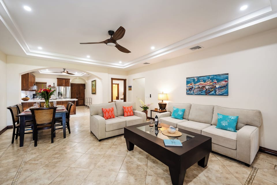 Beachfront living room at Horizontes del Mar, Playa Langosta. Open design flows to balcony and garden patio, just steps from the sand. Costa Rica condo rental near Tamarindo with coastal décor, family‑friendly comfort, and ocean breeze lifestyle.