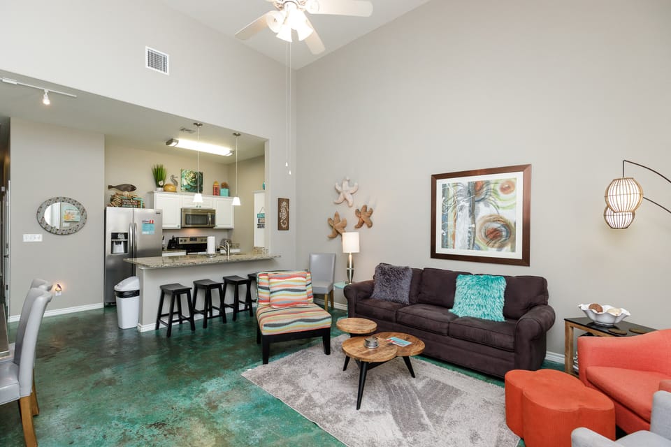 Relax in your bright, modern living space with stylish furnishings, comfortable seating, and a fully equipped kitchen just steps away.
