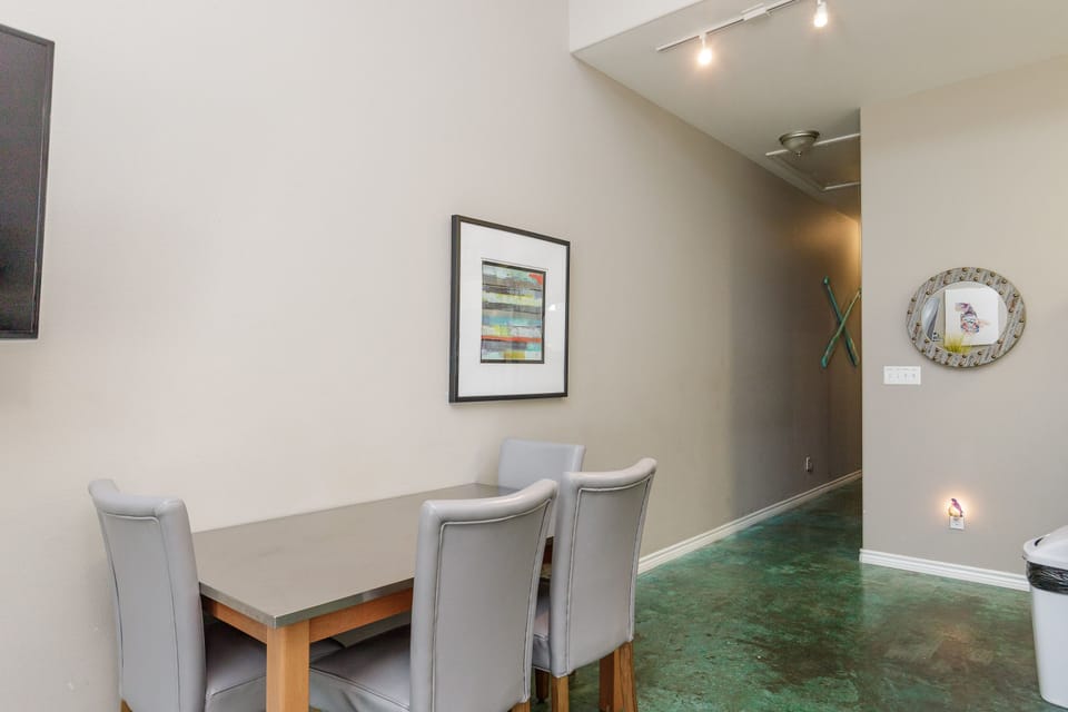 Gather around your stylish dining table for memorable meals in this thoughtfully designed space with modern artwork and polished concrete floors.