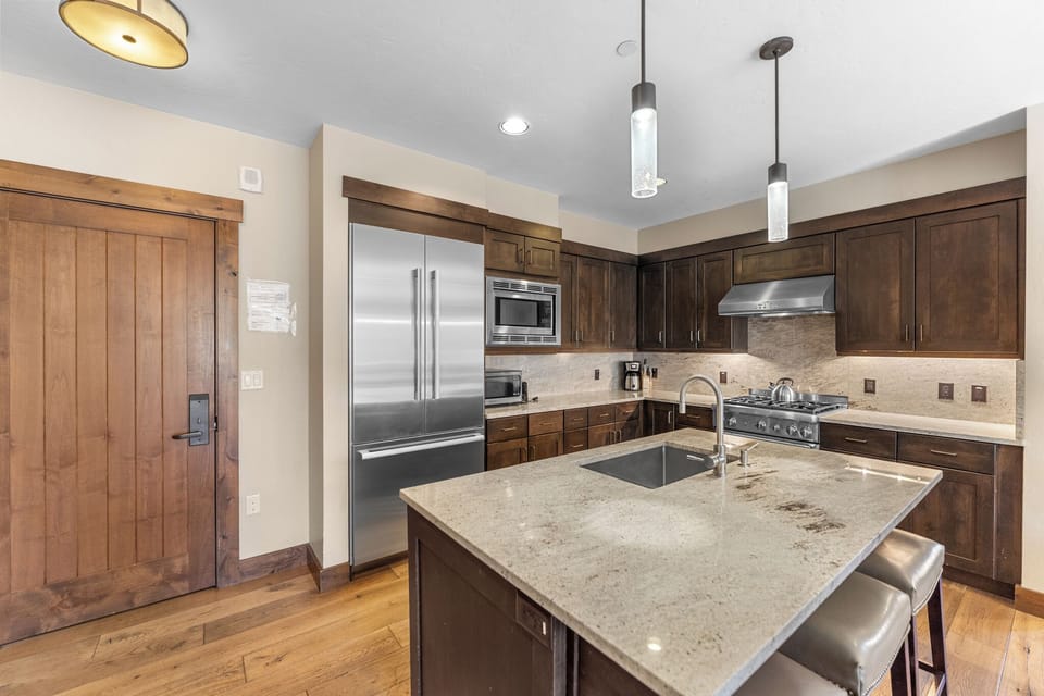 You'll love cooking in this gourmet kitchen with granite counters, stainless steel appliances, and warm wood cabinets.
