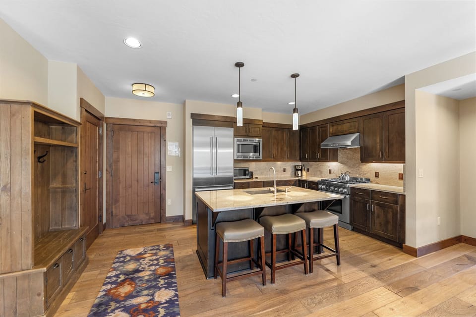 Your gourmet kitchen awaits with granite counters, stainless appliances, and a breakfast bar perfect for morning coffee.