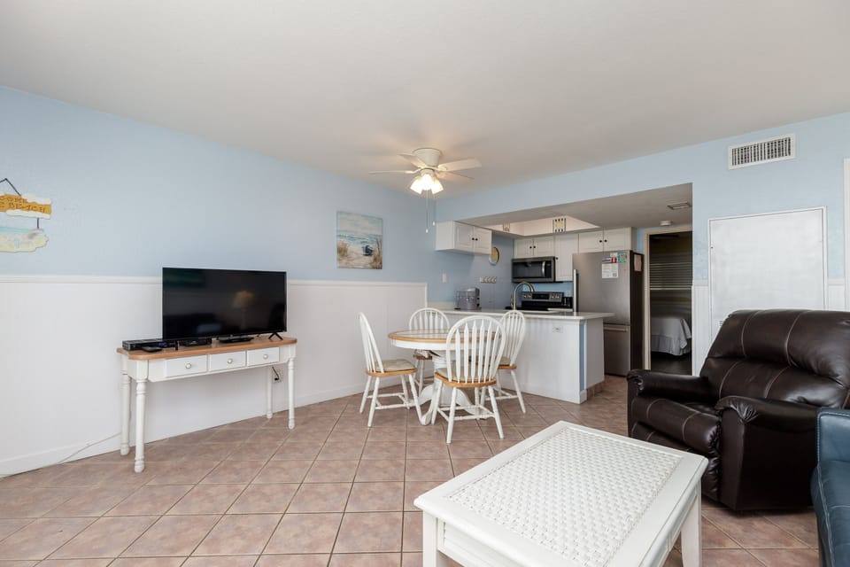 Unwind in your open-concept living space with modern kitchen, cozy dining nook, and comfortable leather seating.