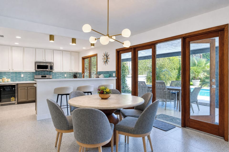 Gather around this inviting dining space where natural light streams through and your private patio awaits, perfect for morning coffee or sunset meals together.