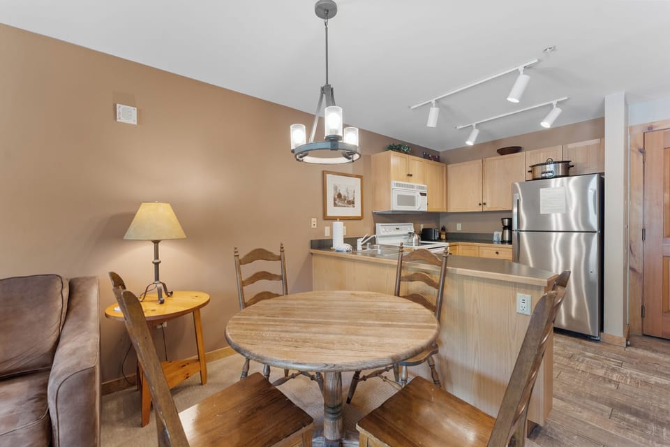Your open kitchen and dining area features modern appliances and warm wood finishes, perfect for preparing meals and gathering together.
