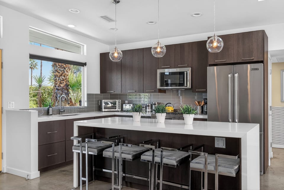 Your modern kitchen awaits with sleek pendant lighting, granite counters, and stainless appliances for effortless meal prep.