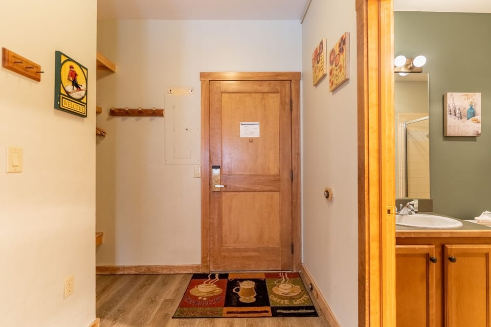 Step into your cozy entrance featuring warm wood accents, charming artwork, and thoughtful details that welcome you home.